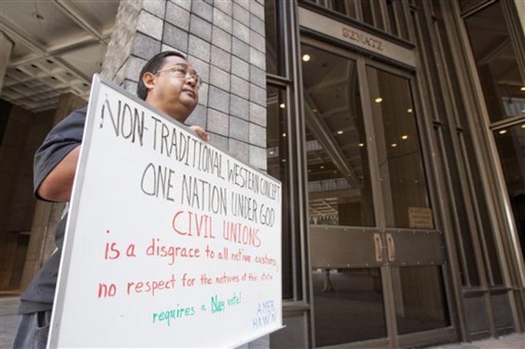 Enrick Ortiz of Kahaluu holds a sign Tuesday outside the Hawaii State Senate Chambers expressing his feelings against the Civil Unions bill at the Hawaii State Capitol in Honolulu.